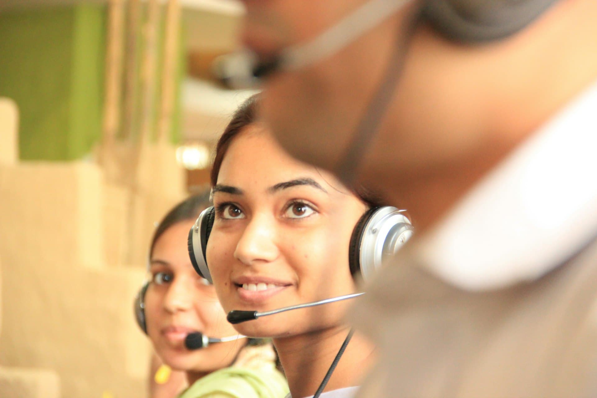 A customer support agent wearing a headset, ready to help